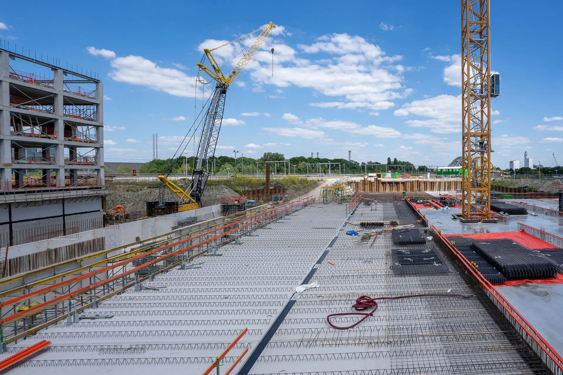 Concrete deck of a building under construction with tower cranes